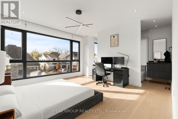Modern kitchen island, dining area, and living room - 111 Millpond Road Niagara On The Lake