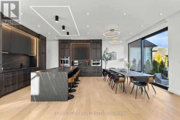 Modern home with large windows, garage, and concrete driveway - 111 Millpond Road Niagara On The Lake