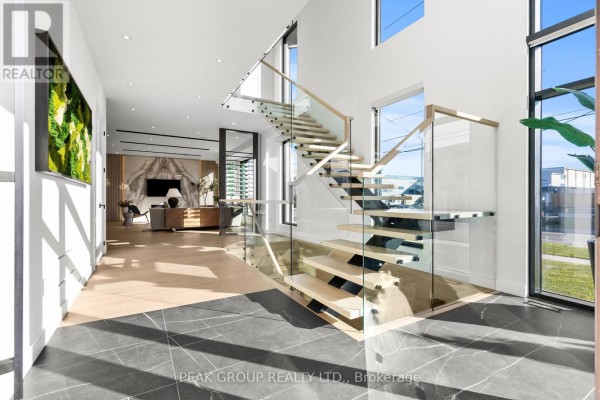 Modern home exterior with garage door and large windows - 111 Millpond Road Niagara On The Lake