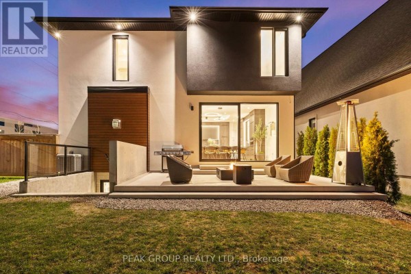 Modern home with large windows and wood siding - 111 Millpond Road Niagara On The Lake