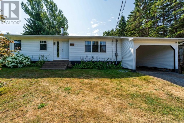Front exterior of a white ranch-style house with a carport on the right side. - 111 Prince William Street, Digby