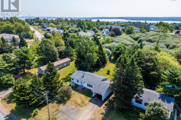 Aerial view of the property and surrounding neighborhood with distant water view. - 111 Prince William Street, Digby