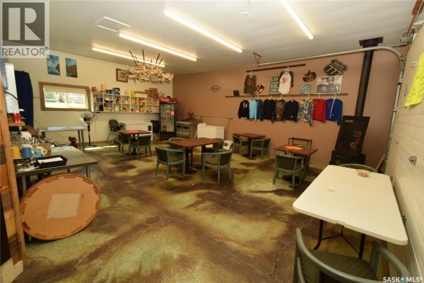 Interior view of the commercial space with tables, chairs, and merchandise displays. - 111 Railway Avenue N, Middle Lake