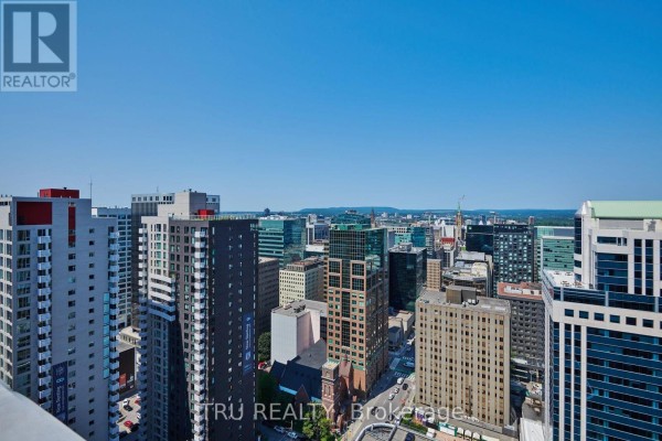 View of Ottawa city skyline with tall buildings and clear blue sky from above. - 1110 - 179 Metcalfe Street, Ottawa