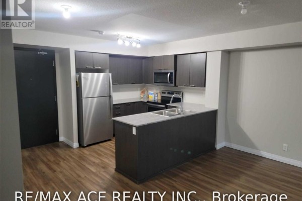 Kitchen with dark cabinetry, stainless steel appliances, and a grey granite countertop island. - 1110 - 2152 Lawrence Avenue E, Toronto