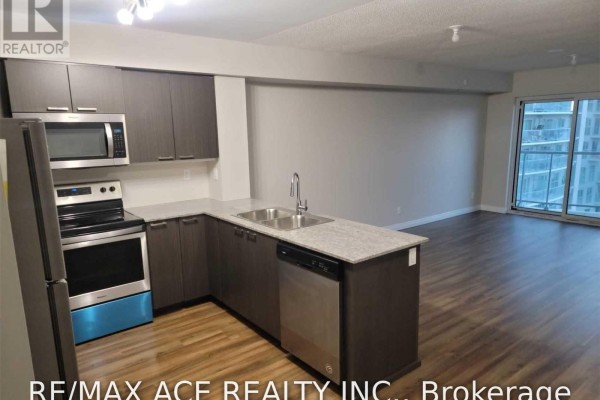 Kitchen with dark wood cabinets, granite counters, stainless steel fridge, stove, and dishwasher. - 1110 - 2152 Lawrence Avenue E, Toronto