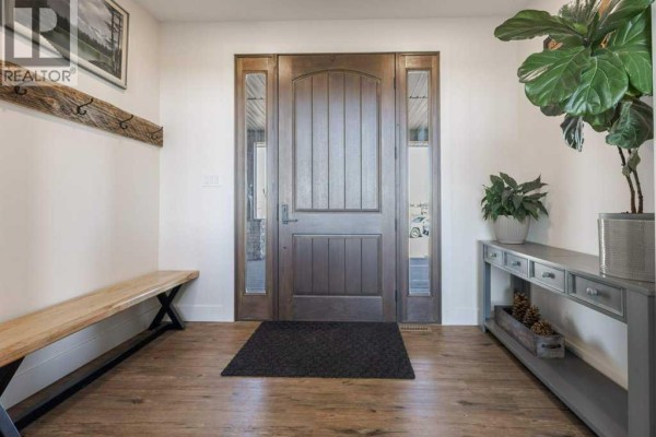 Interior entryway with a dark wood door, sidelights, a wooden bench, and a console table. - 111072 Rr#151, Purple Springs