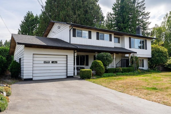 Front view of a white two-story house with a covered porch and attached garage. - 11142 Patricia Drive Drive, Delta
