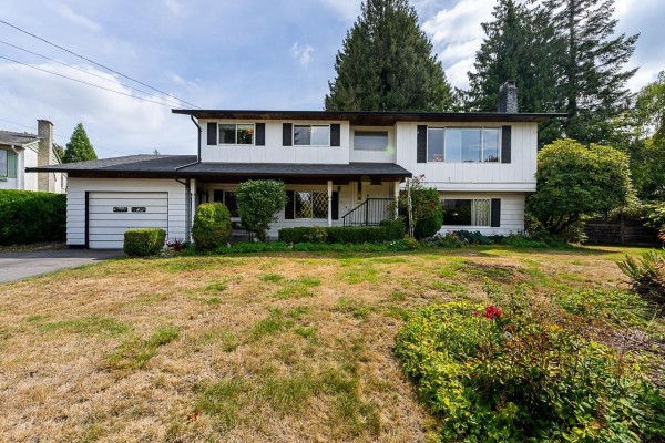 Front facade of a white two-story residential home with a manicured lawn and bushes. - 11142 Patricia Drive Drive, Delta