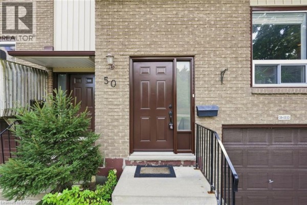 Close-up view of a townhouse front door and garage with house number 50. - 1115 Paramount Drive Unit# 50, Stoney Creek