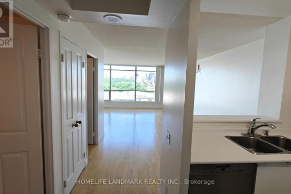 Hallway of the apartment leading to the living area with large windows. - 1116 - 942 Yonge Street, Toronto