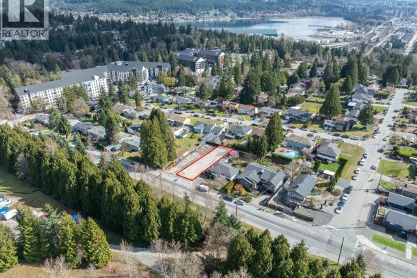 Aerial view of lot for sale on Glenayre Drive, surrounded by homes and trees, distant view of water. - 1116 Glenayre Drive, Port Moody