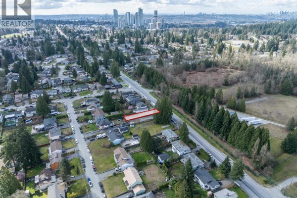 Aerial view showing proximity of lot to suburban homes, roads, and distant city skyline. - 1116 Glenayre Drive, Port Moody