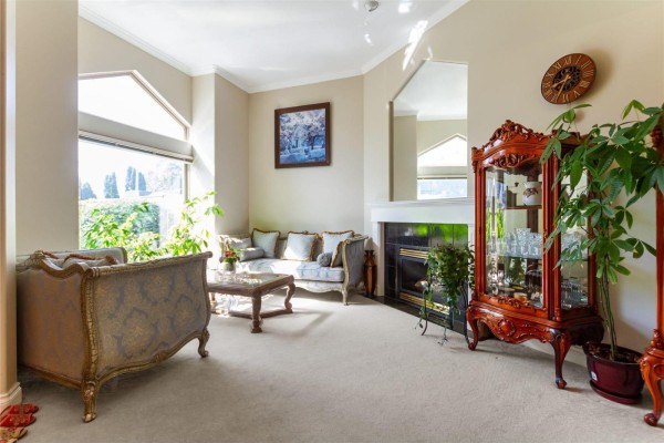 Living room featuring a fireplace, antique furniture, and plants - 11167 160a Street, Surrey