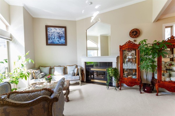 Bright sitting area with large windows and elegant sofas - 11167 160a Street, Surrey