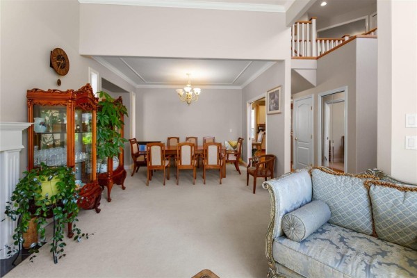Open dining area adjacent to living room, with chandelier and decorative plants - 11167 160a Street, Surrey