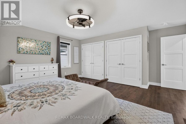Bedroom with king bed, dresser, and closet doors - 112 Argile Street Casselman
