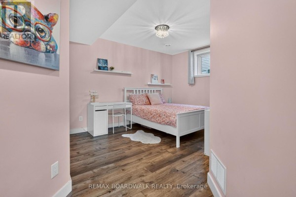 Bedroom with white bed, desk, and shelves - 112 Argile Street Casselman