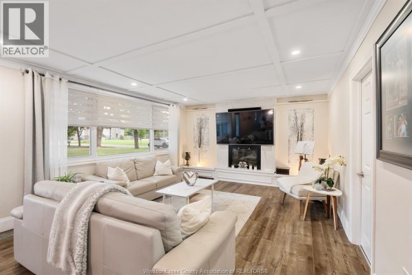 Living room with sectional sofa, modern fireplace, TV & coffered ceiling - 112 Clovelly Tecumseh