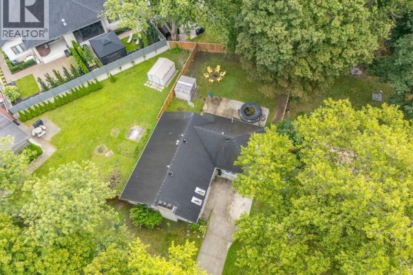 Spacious backyard with mature trees, hot tub, fire pit, and sheds - 112 Clovelly Tecumseh
