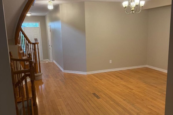 Open concept living and dining room with hardwood floors and a chandelier. - 112 Gatespark Private Private E, Ottawa