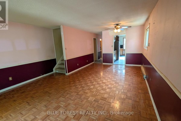 A bedroom with tan carpet, neutral walls, two windows, and a closed closet door. - 112 Marlborough Avenue, London South