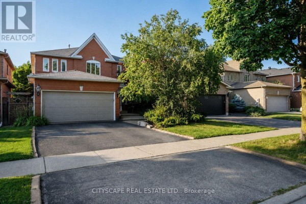 Exterior view of a red brick house with a wide driveway and two garage doors in daylight. - 112 Mulholland Drive, Vaughan