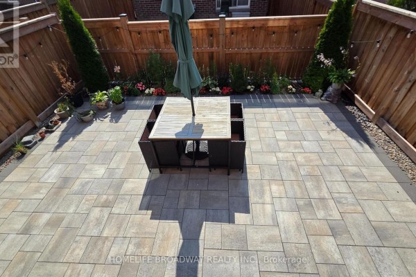 Close-up of townhouse entrance with brick exterior, decorative doors, and attached garage. - 112 Ness Drive, Richmond Hill
