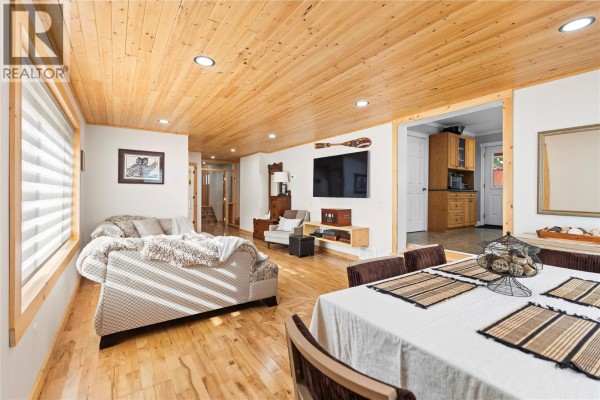 Open-concept living space showing seating area and dining table with natural light. - 112 Walker Road, Clearwater