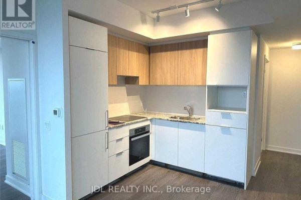 Modern kitchen with light wood cabinetry, granite countertops, and stainless steel appliances. - 1120 - 20 O'neill Road, Toronto