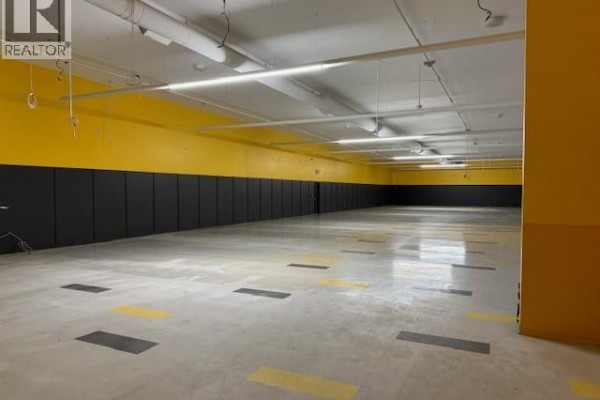 Spacious empty area with yellow and black accents on walls - 1121 102nd Street, North Battleford