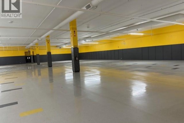 Large open floor plan with polished concrete and yellow details - 1121 102nd Street, North Battleford