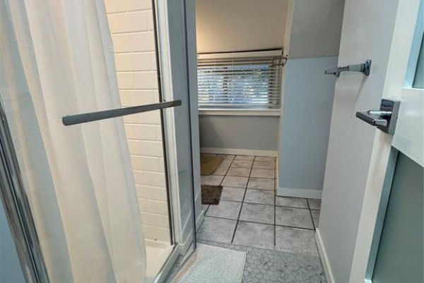 Shower stall with white subway tile and a glass door next to a tiled floor. - 1124 Janette Avenue Unit# Room Lvl 2, Windsor