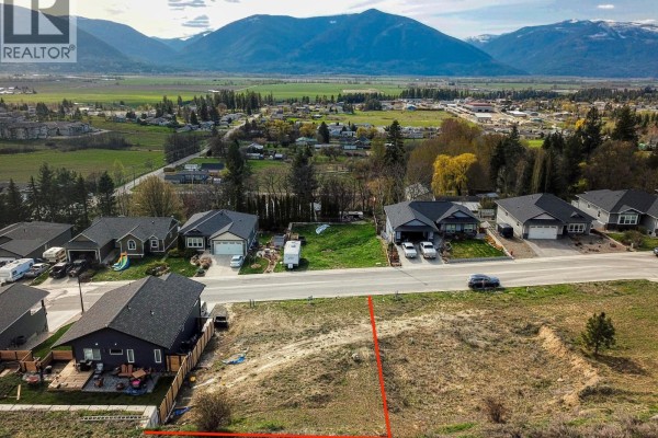 View of the valley and mountains from the lot, with nearby homes visible. - 1126 12th Avenue N, Creston