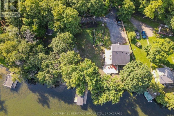 Waterfront property with house, dock, garden, and trees - 1127 Perry Lane Frontenac