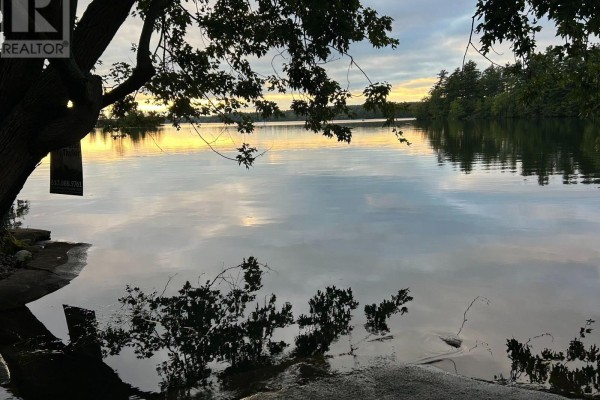 Waterfront property with trees and sunset reflections - 1127 Perry Lane Frontenac
