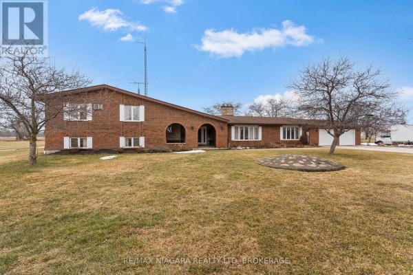 Aerial view of the property showing the house, yard, and surrounding landscape. - 11292 Golf Course Road, Wainfleet