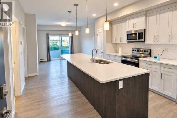 Living room - 113, 4150 Seton Drive Se, Calgary, AB T3M2C7 Photo 2