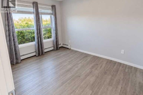 Bedroom - 113, 4150 Seton Drive Se, Calgary, AB T3M2C7 Photo 5