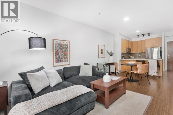 Open concept living and dining area with modern kitchen and seating. - 113 119 W 22nd Street, North Vancouver