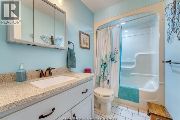 Bathroom with vanity, toilet, and bathtub/shower combo - 113 Beach Court Stoney Point