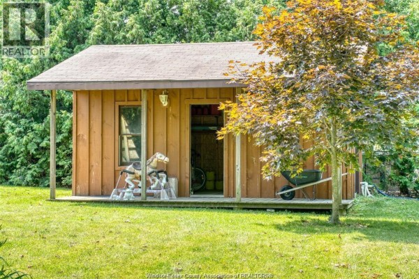 Wooden shed with rocking horse and wheelbarrow - 113 Beach Court Stoney Point