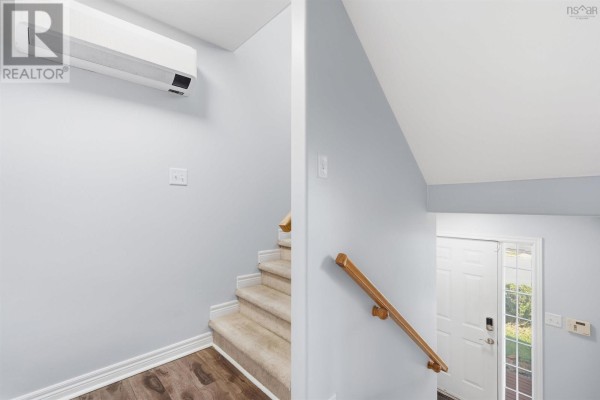 Interior view of a staircase with beige carpet and a light blue wall. - 113 Feruz Crescent, Halifax