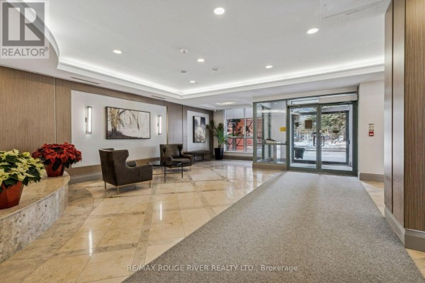 Lobby area with marble flooring, modern lighting, and seating arrangements. - 1136 - 125 Omni Drive, Toronto