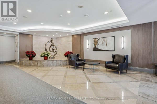 Living room featuring hardwood floors, large bay windows, and a grandfather clock. - 1136 - 125 Omni Drive, Toronto