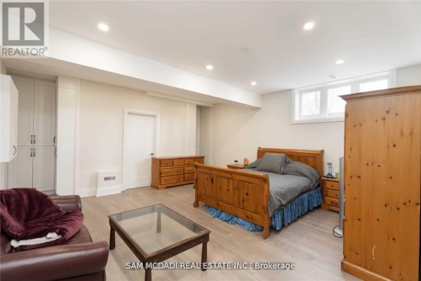Bedroom with wood bed, dresser, wardrobe, sofa, and coffee table - 1138 Garden Road Mississauga