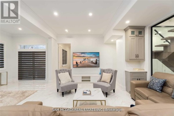 Living room with modern staircase, TV, and seating - 1138 Garden Road Mississauga