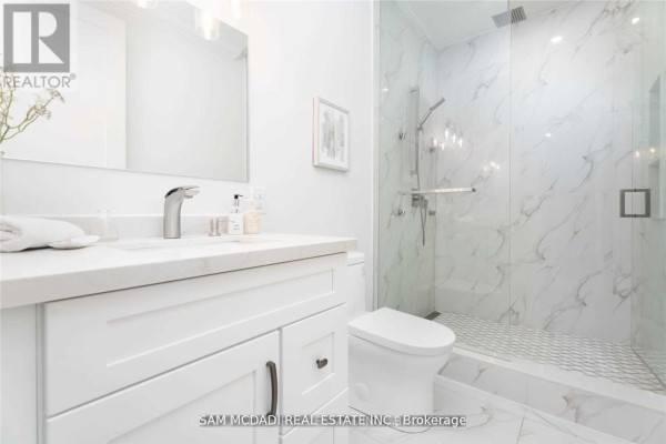 Modern bathroom with vanity, marble shower, and mosaic tile floor - 1138 Garden Road Mississauga