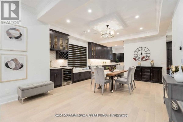 Dining room with wine fridge, table, chairs, and dark cabinets - 1138 Garden Road Mississauga