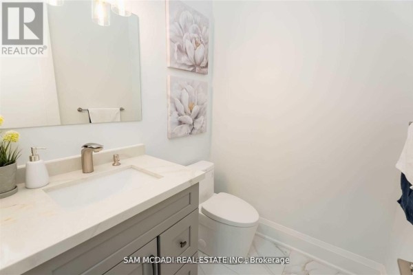 Modern bathroom vanity, vessel sink, marble countertop, and floral art - 1138 Garden Road Mississauga